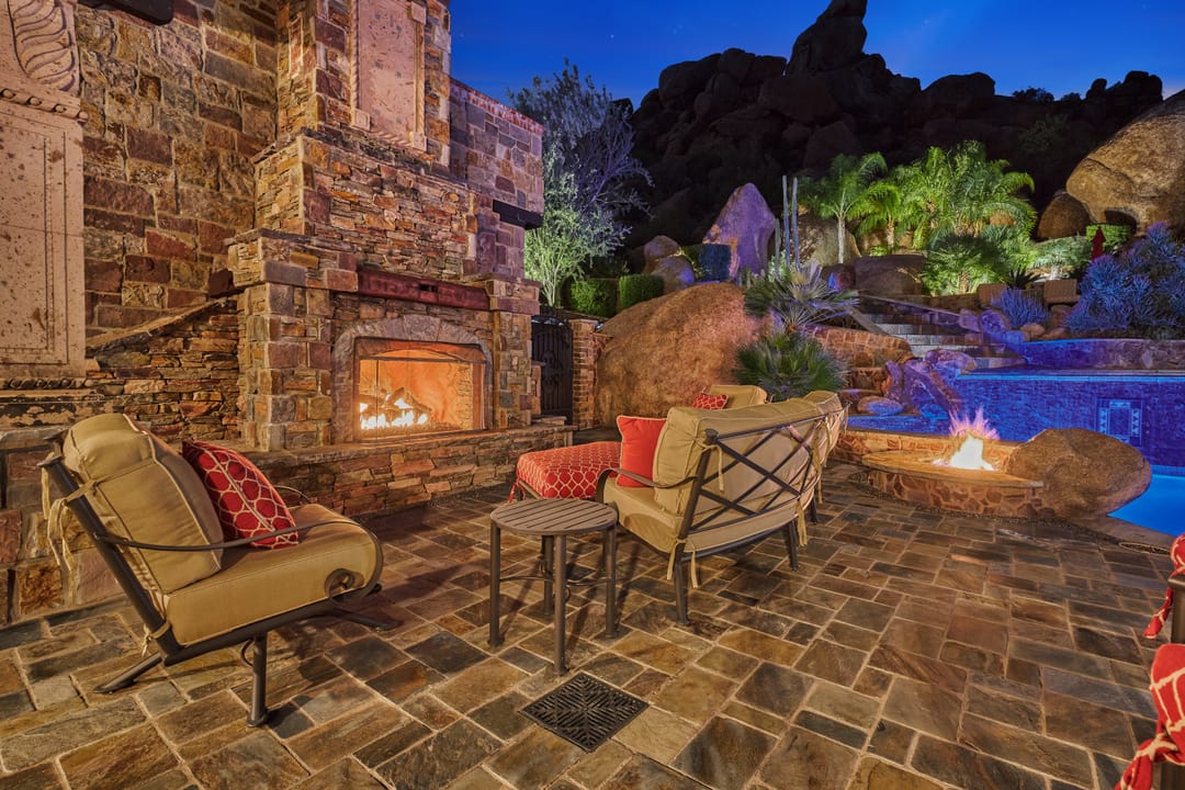 Outdoor patio with fireplace, seating.