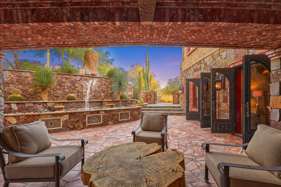 Outdoor patio with stone fountain.