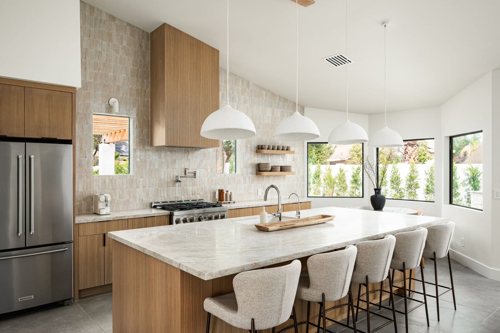 Modern kitchen with island and stools.