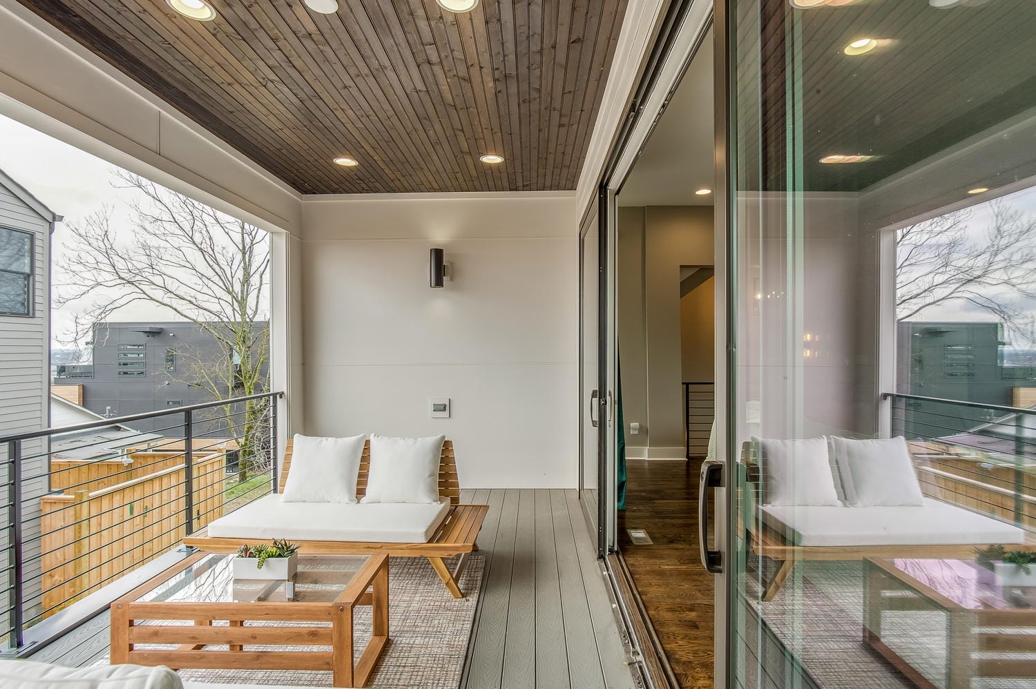 Modern patio with wooden furniture.