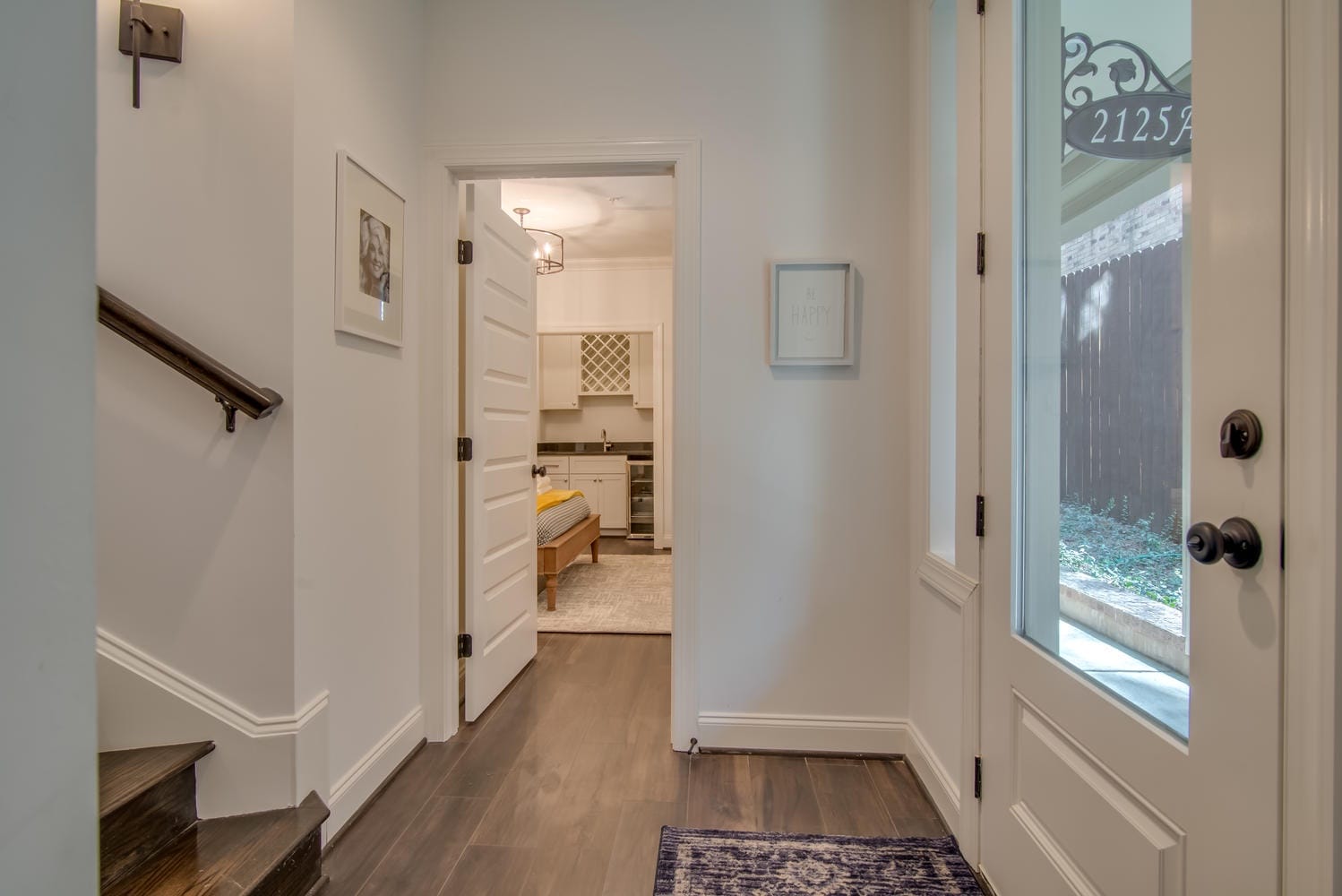 Hallway leading to a furnished room.