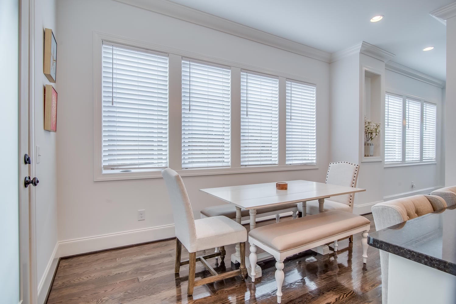 Bright dining area with white furniture.