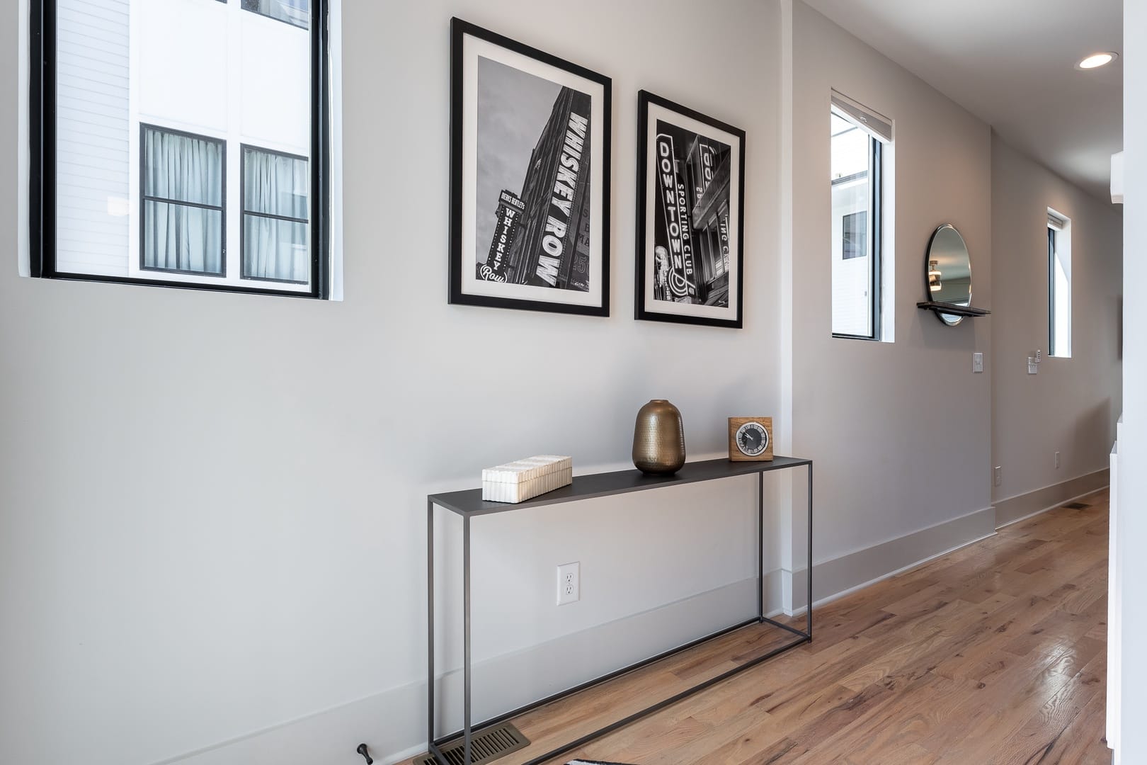 Minimalist hallway with framed photographs.