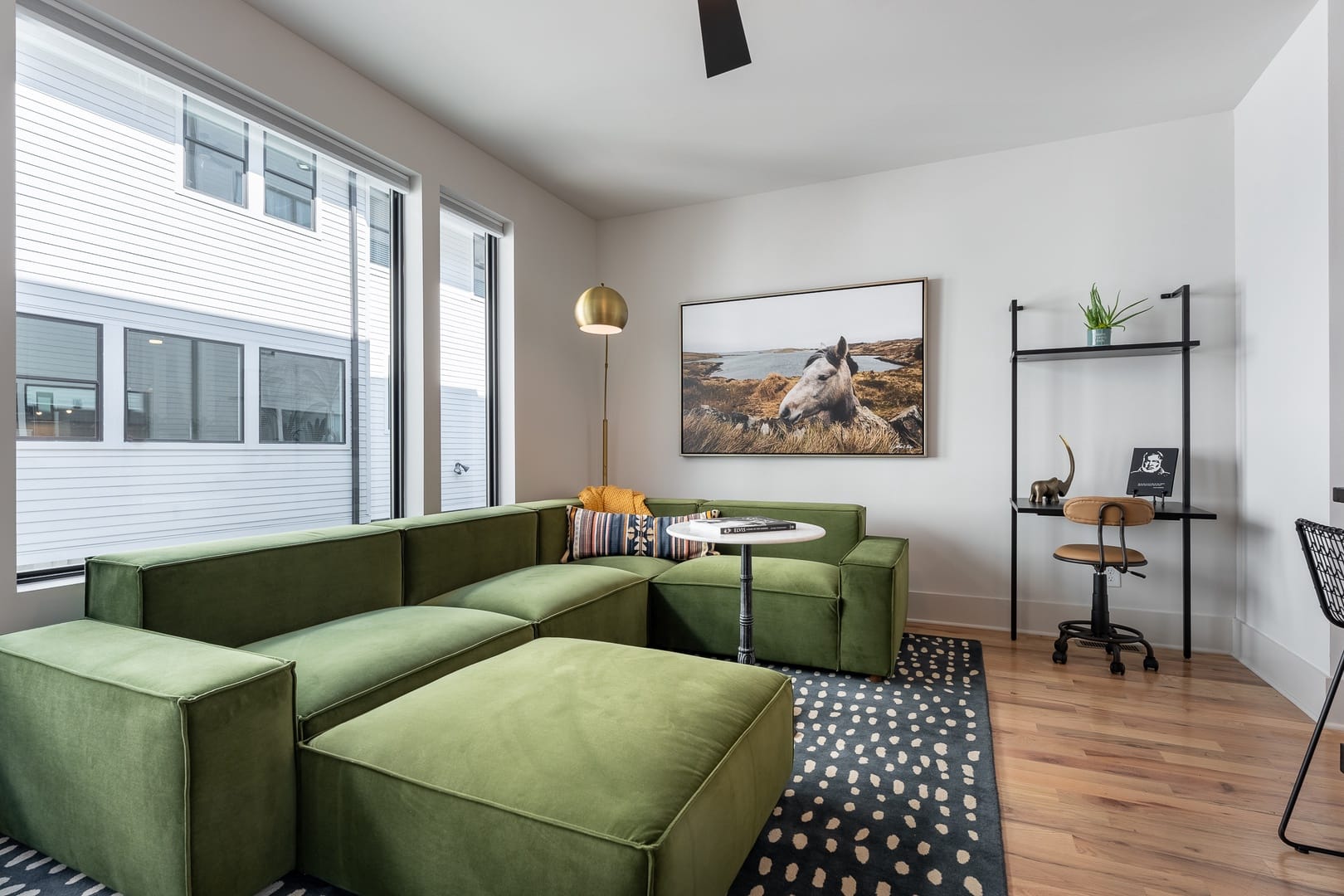 Modern living room with green sofa.