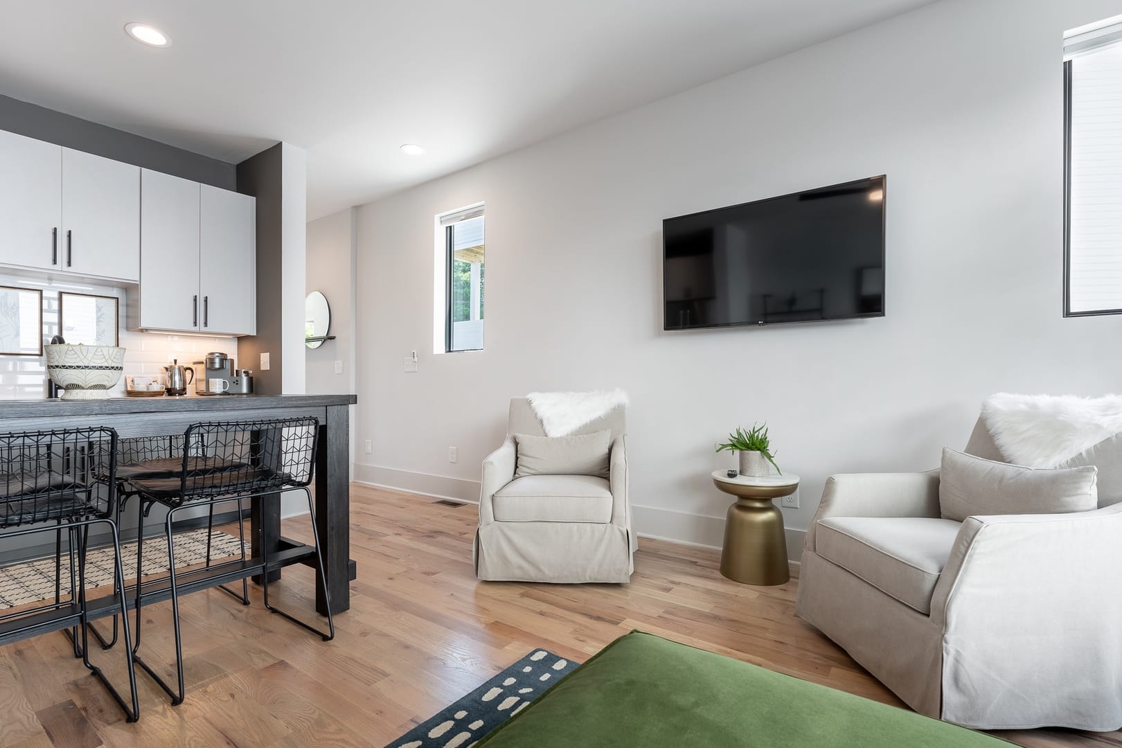 Modern living room with kitchen area.