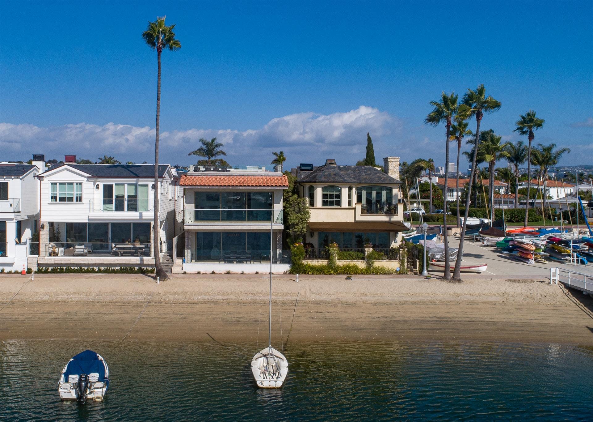 Beachfront houses with docked boats.