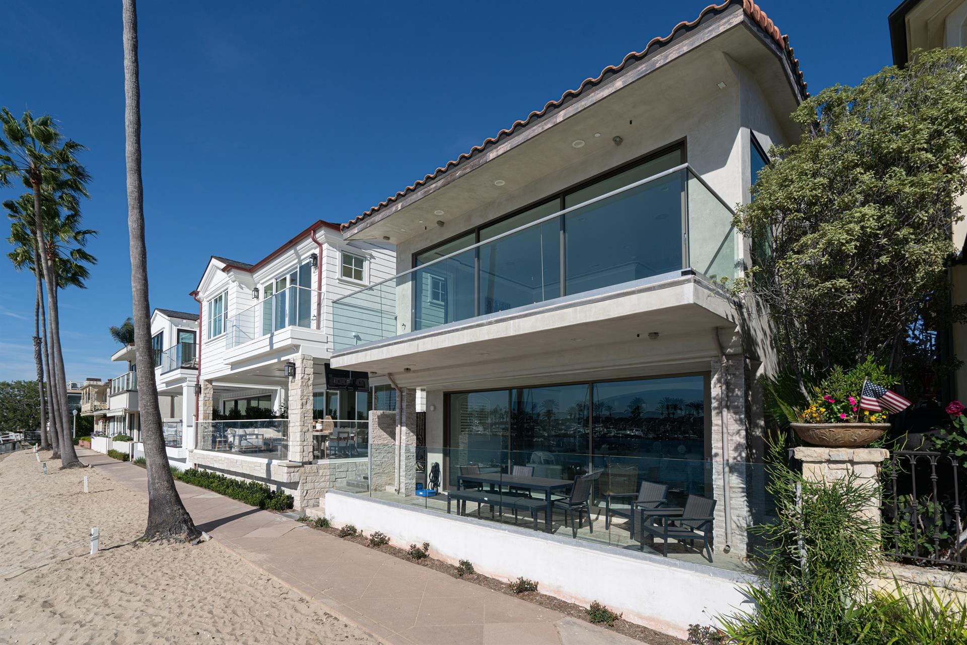 Beachfront modern houses and palm trees