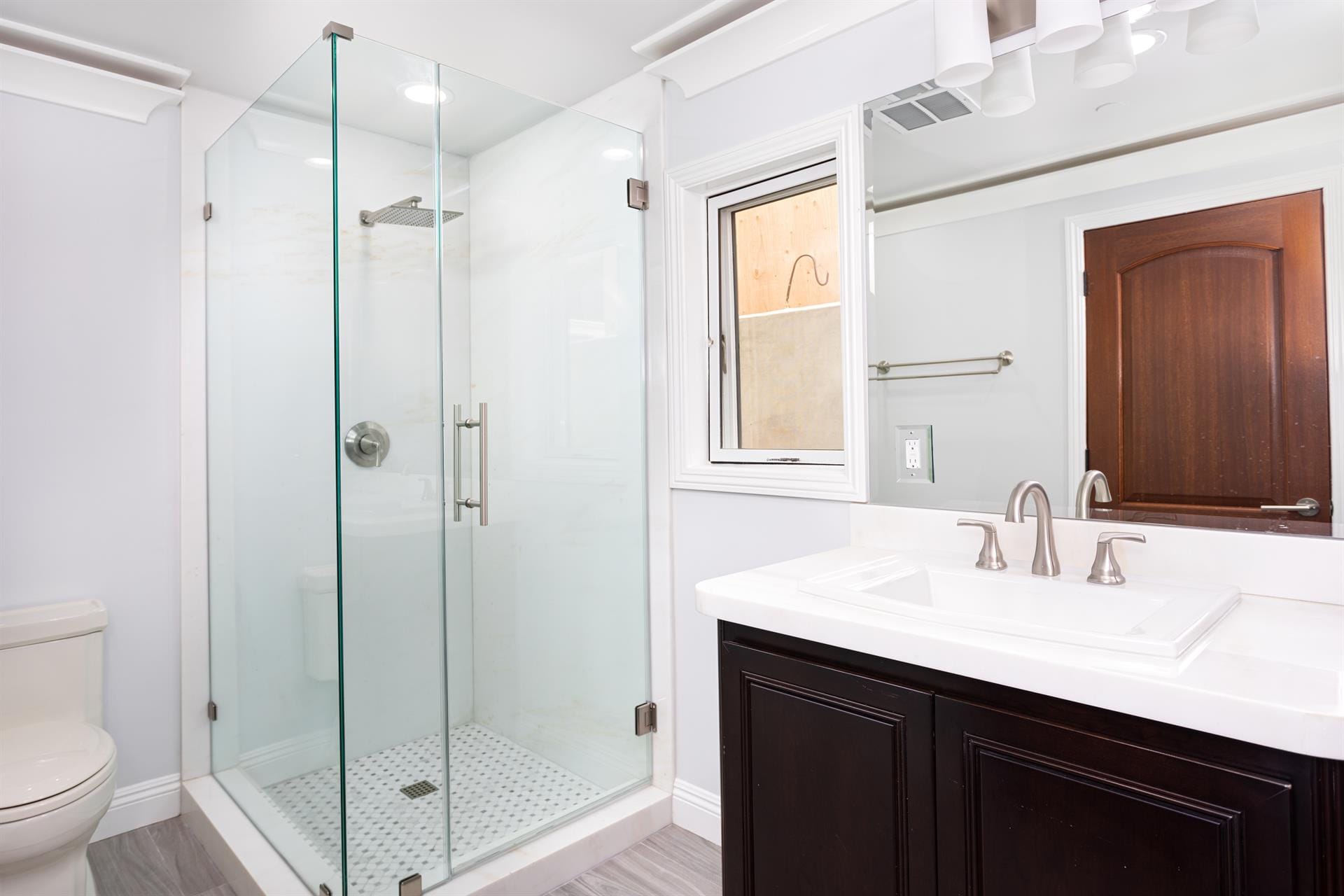 Modern bathroom with glass shower enclosure.