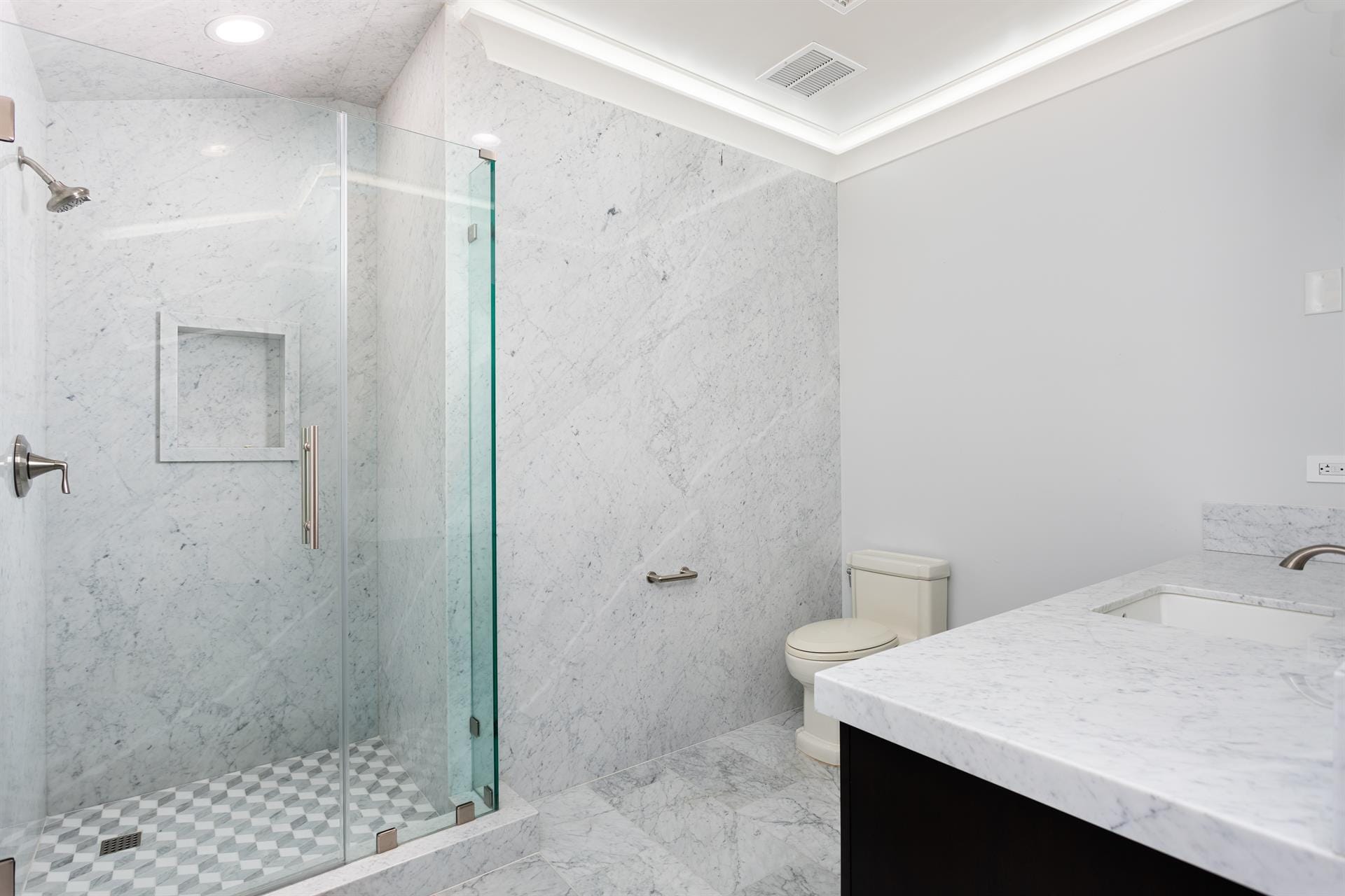 Modern minimalist bathroom with glass shower.