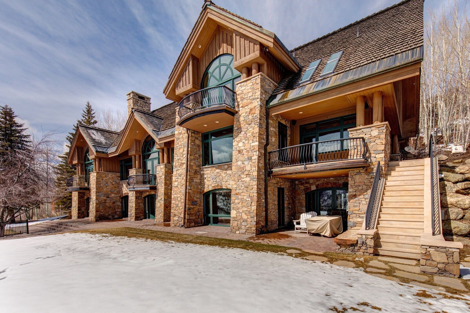 Large stone house, snowy yard.