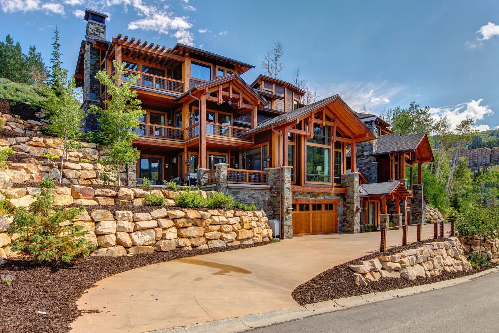 Large modern cabin on hillside.