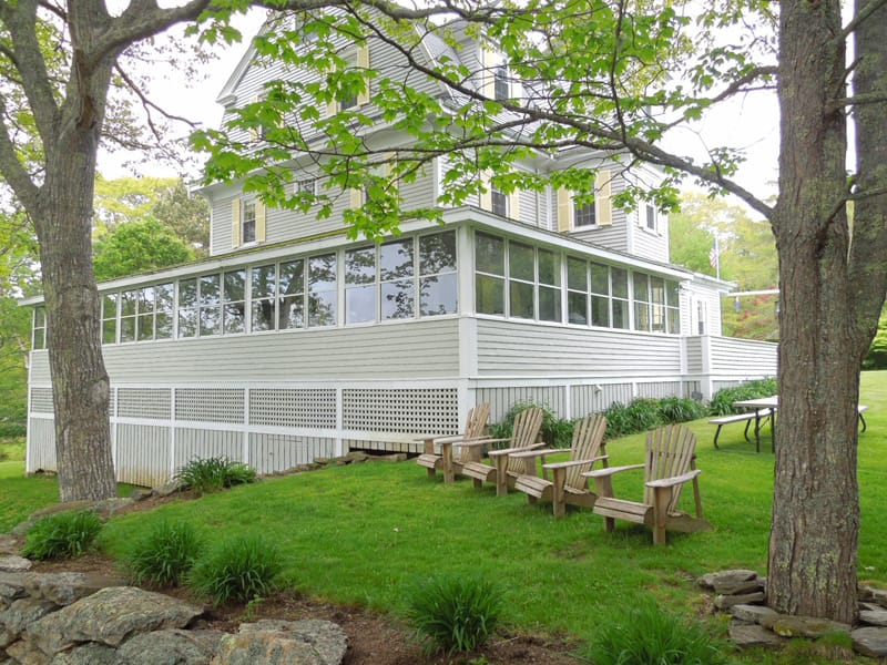 White house with lawn chairs.