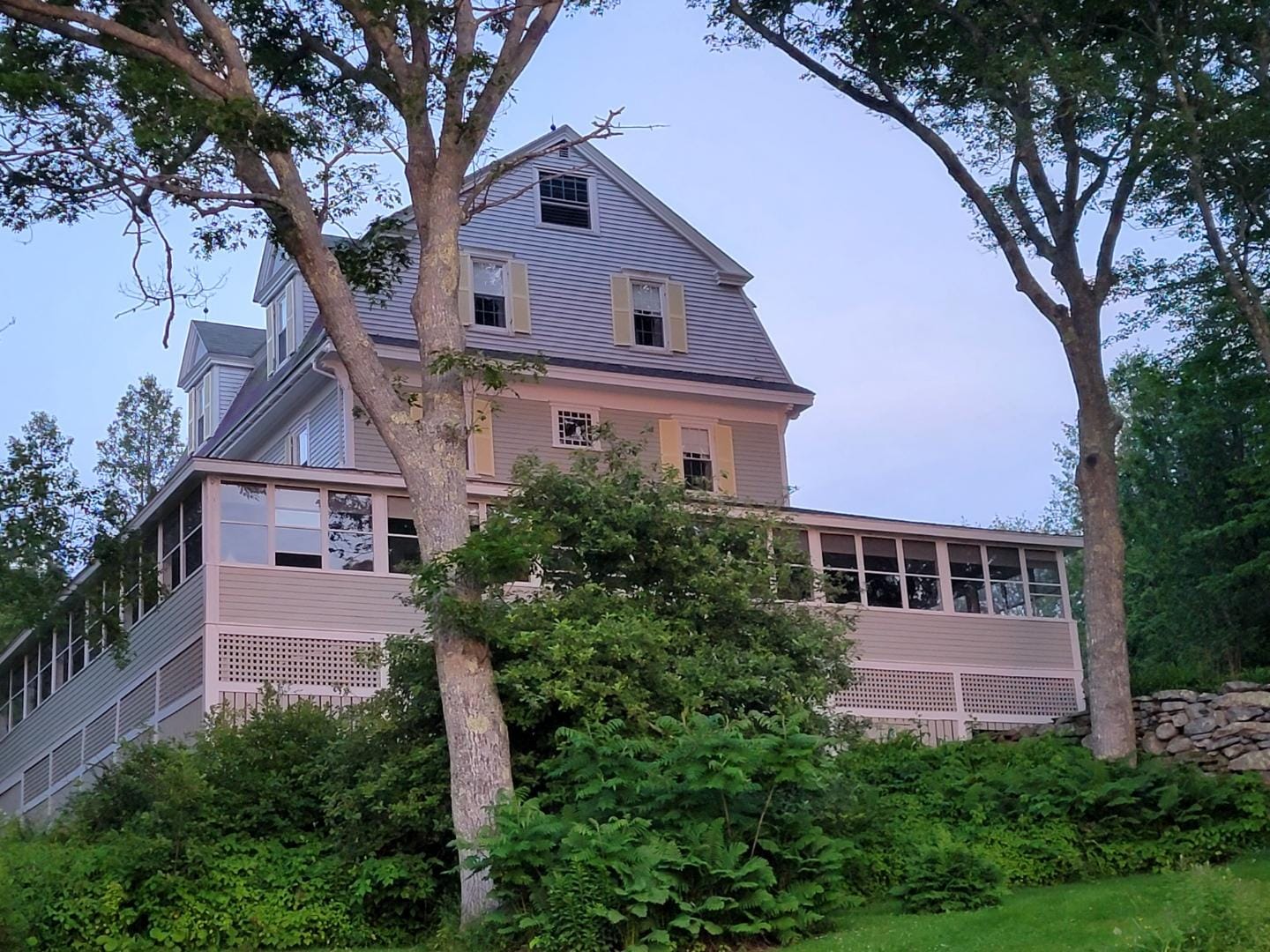 Large house surrounded by trees.