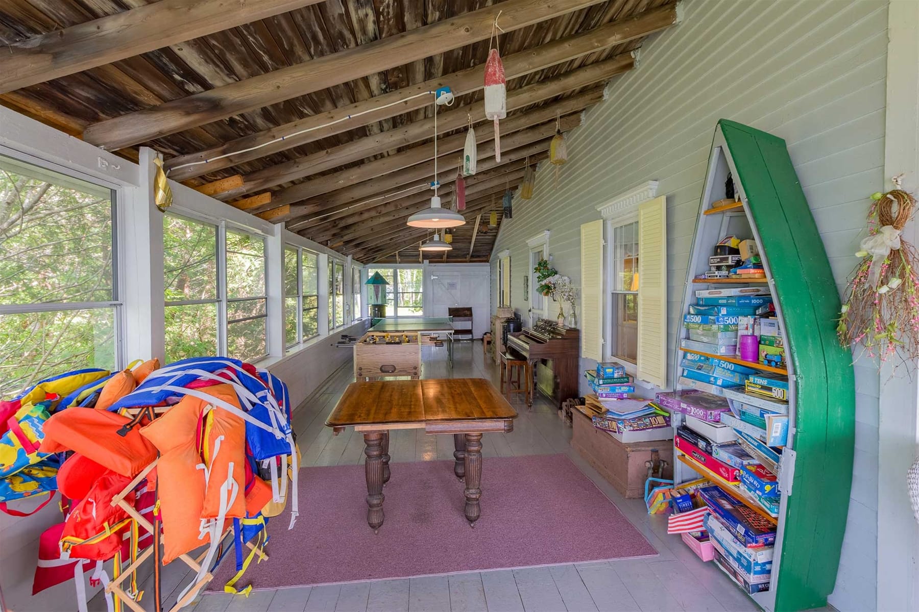 Rustic porch with games and life jackets.