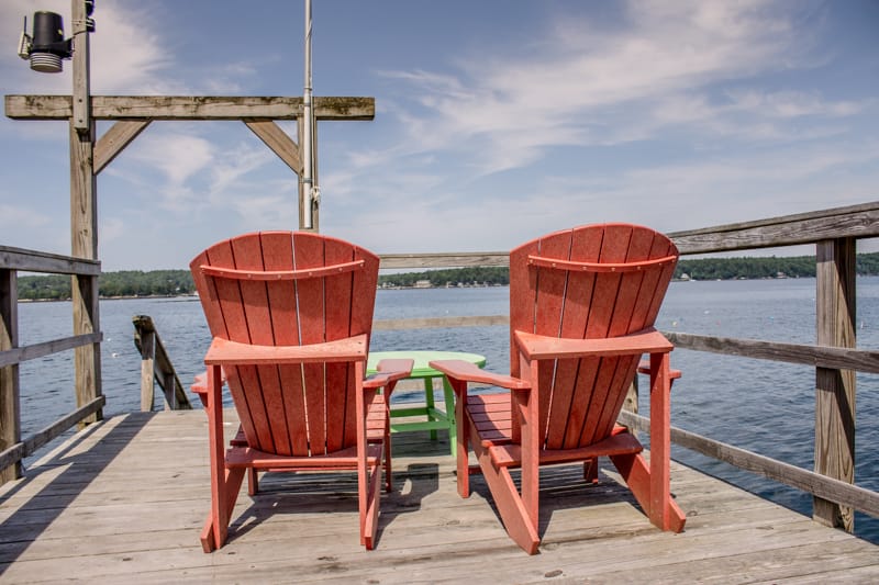 Two chairs on lakeside dock.