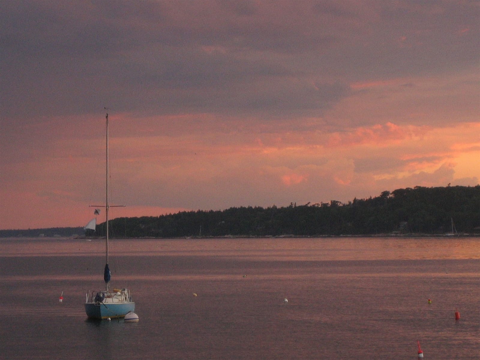 Boat on tranquil water at sunset.