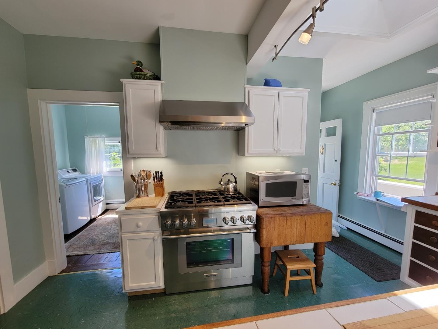 Modern kitchen with green walls.