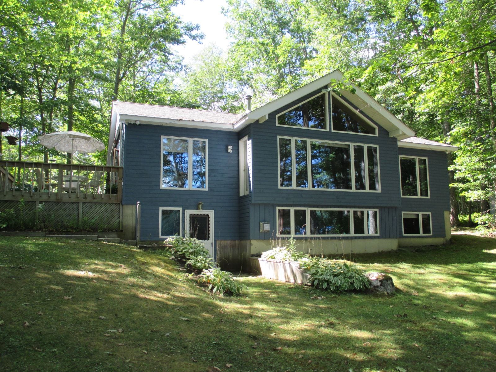 Blue house with large windows.