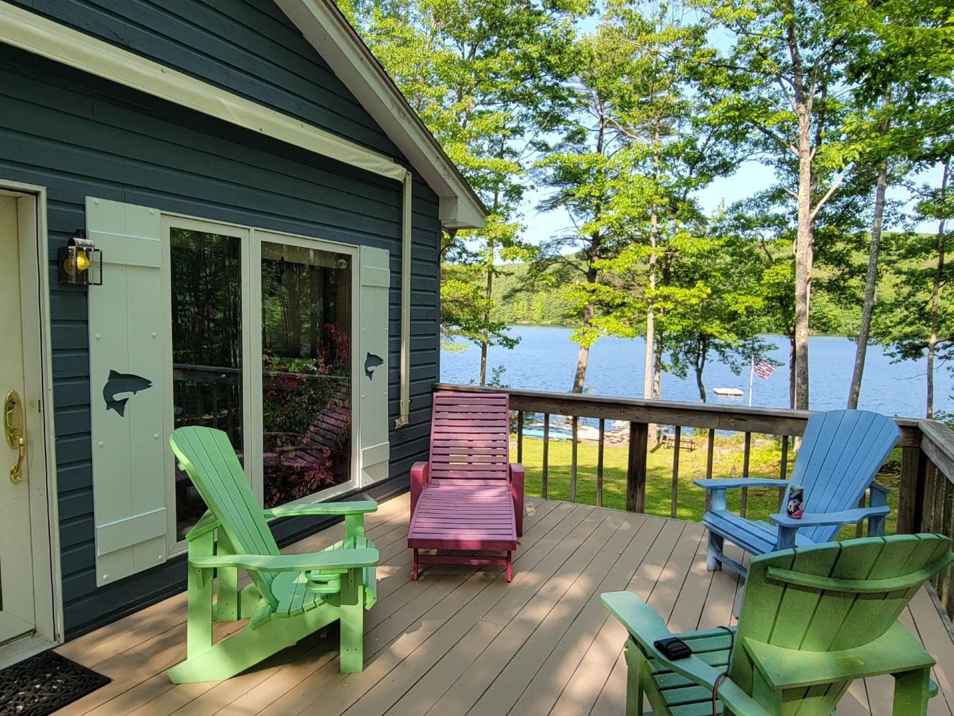 Deck with colorful chairs, lake view.