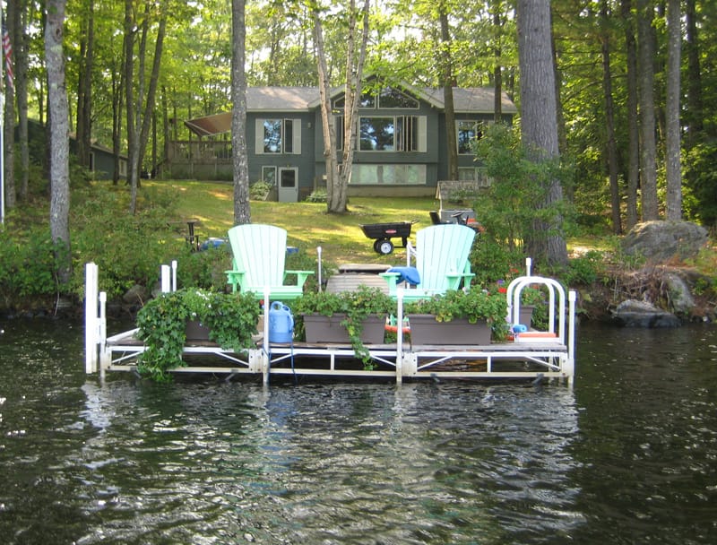 Lakeside dock with two chairs.