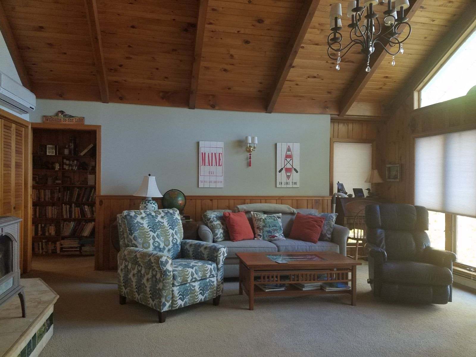 Cozy living room with wooden ceiling.