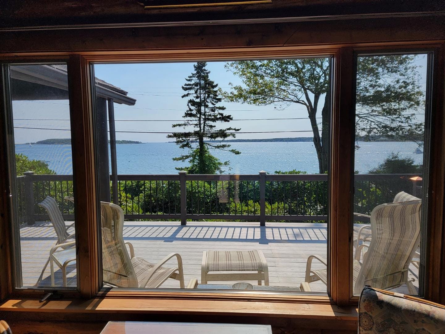 Deck overlooking lake through window.