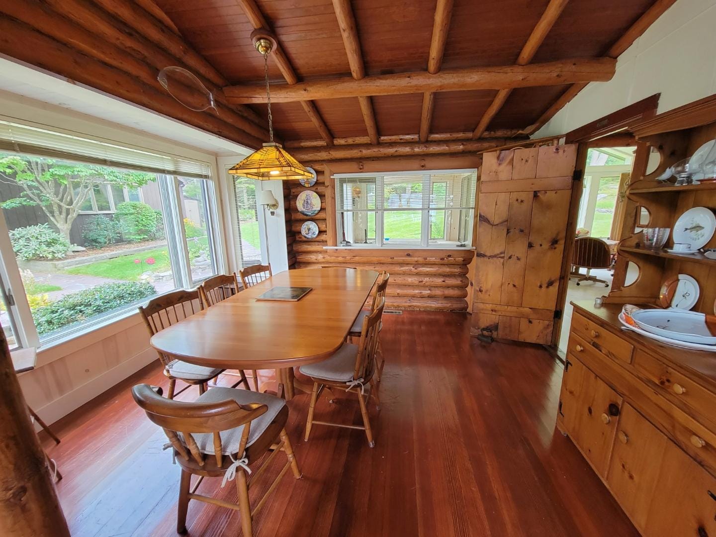 Rustic dining room with wooden furniture.