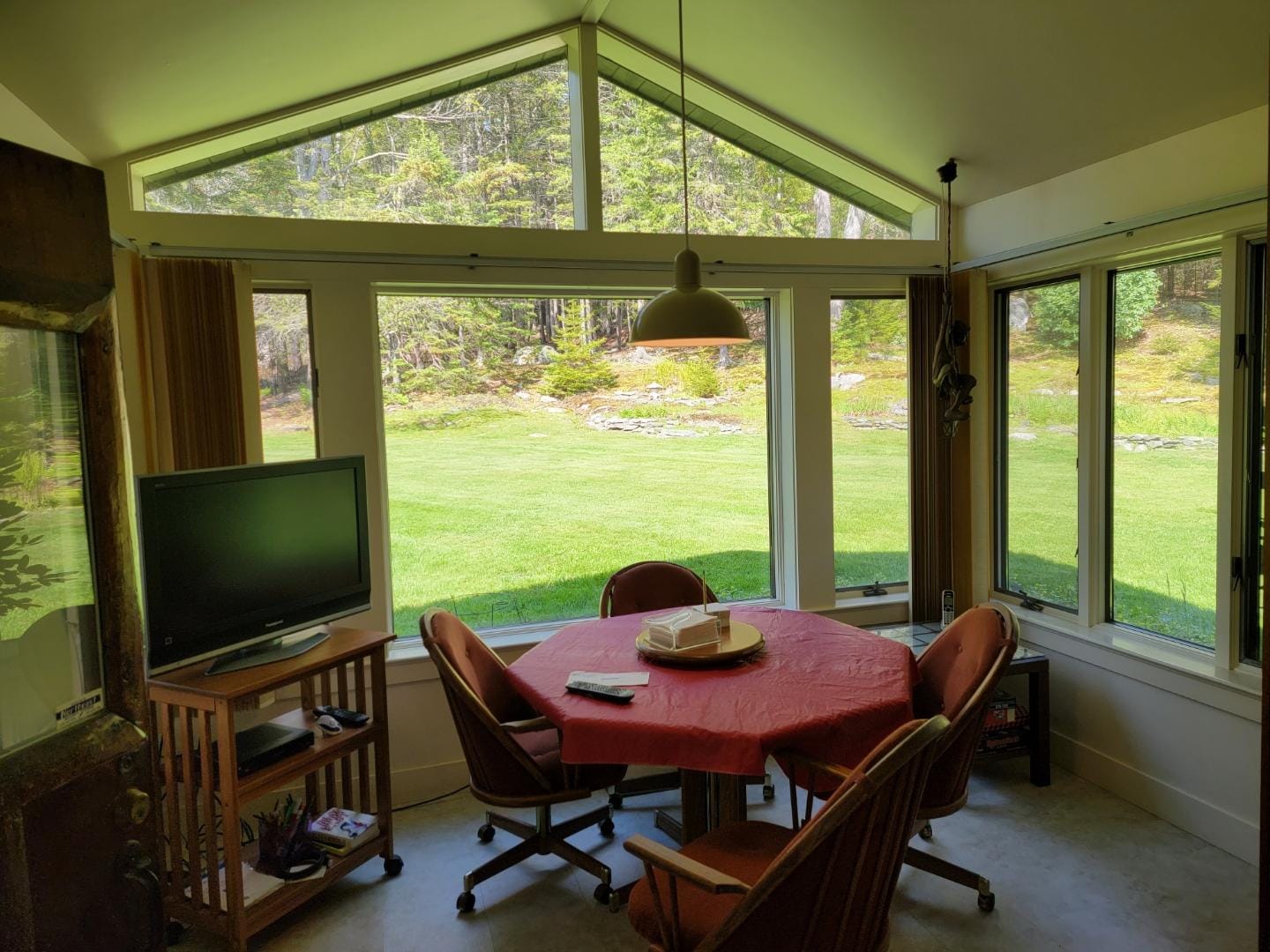 Cozy sunroom with table, chairs.