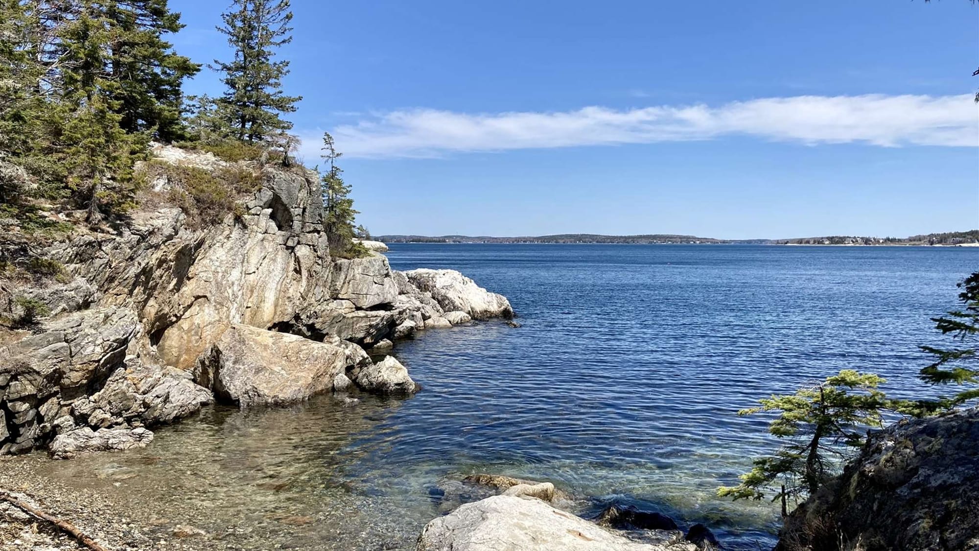 Rocky coastline and calm blue water.