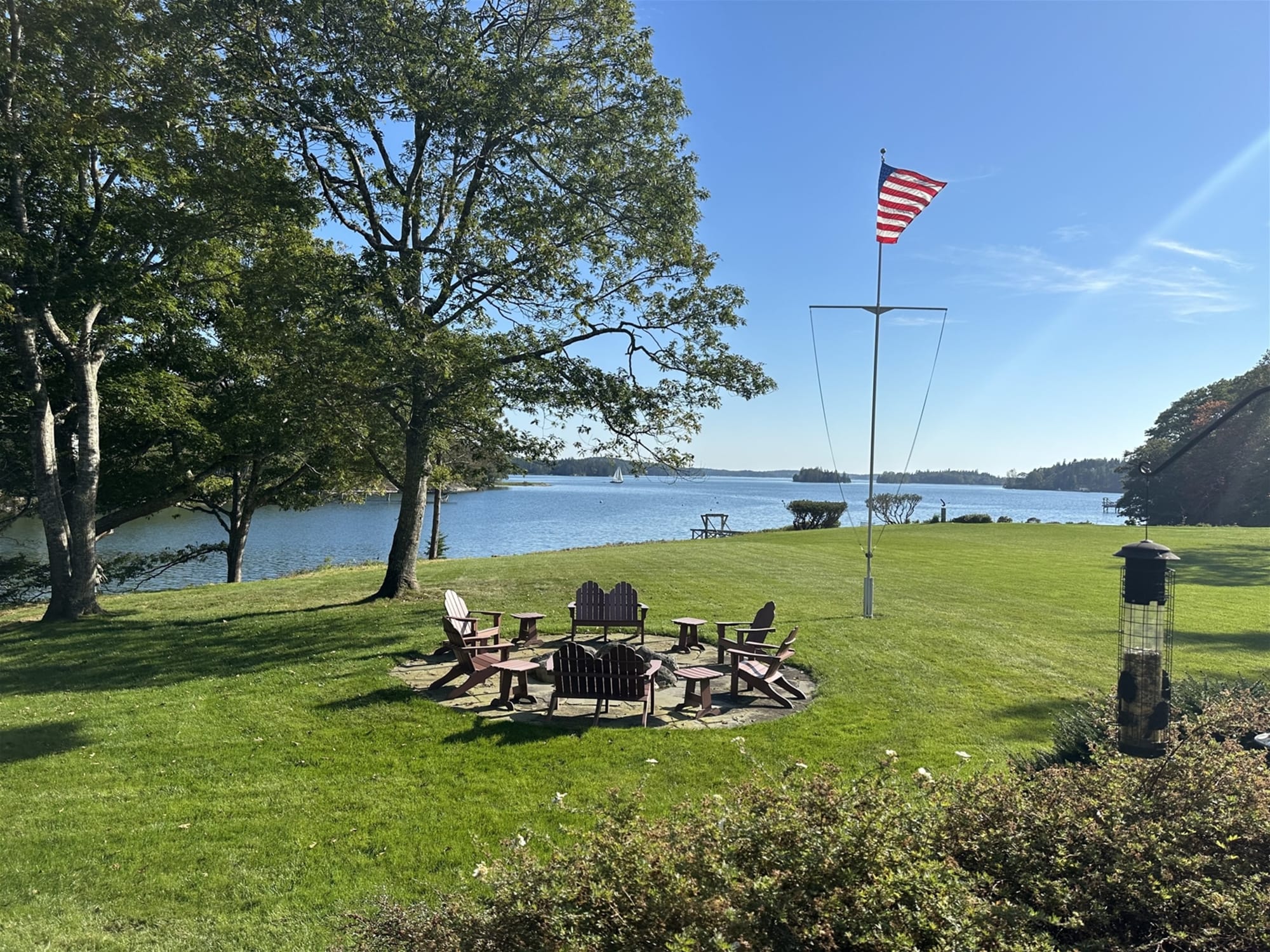 Lakeside chairs near American flag.