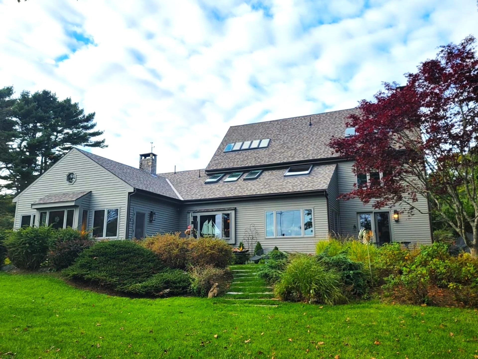 Two-story house with landscaped yard.