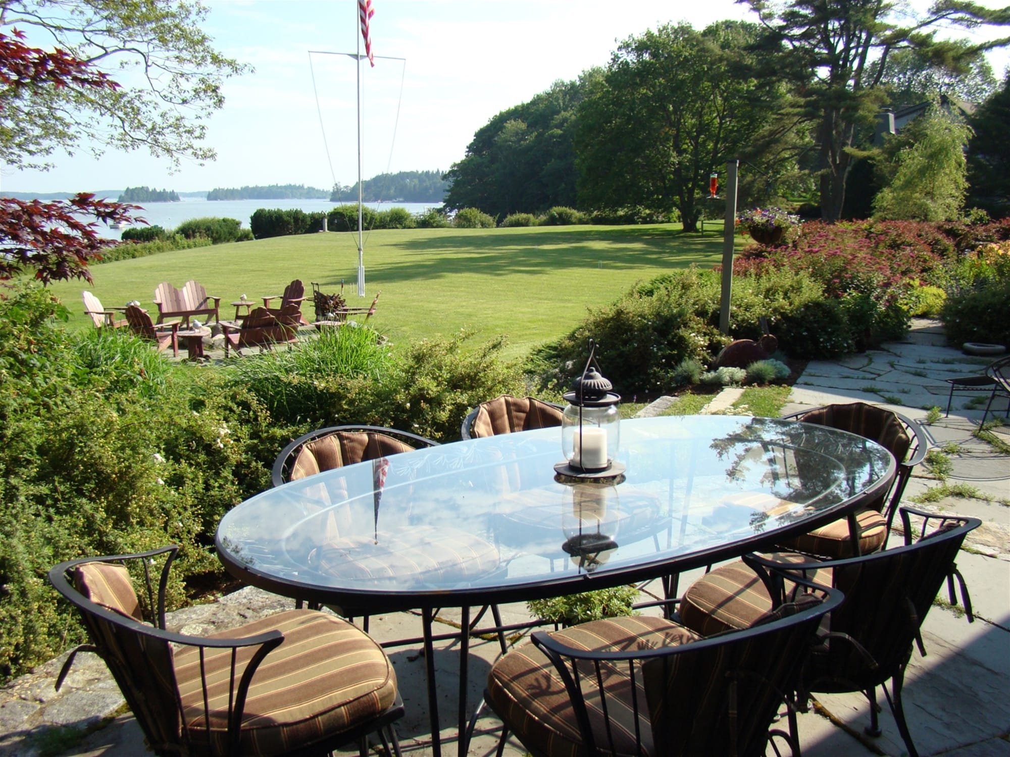 Patio with garden and lake view.