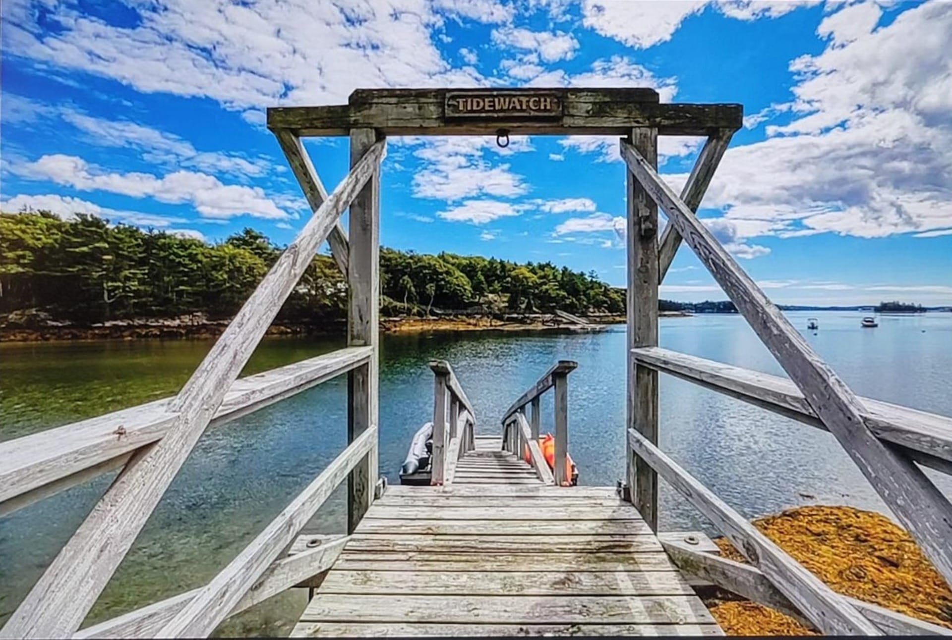 Wooden bridge over calm water.