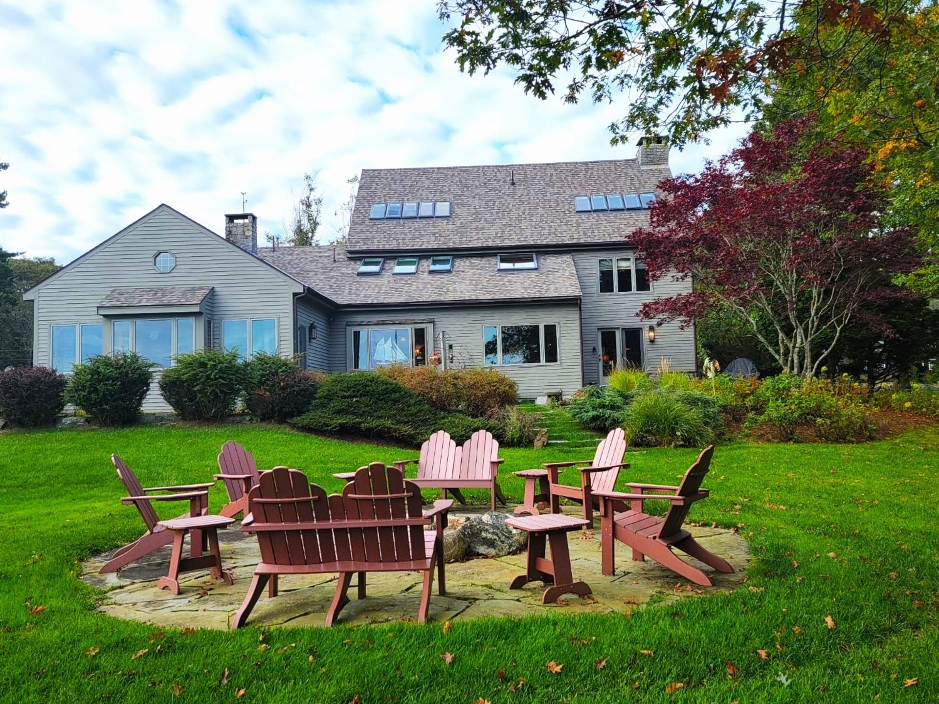 Backyard with chairs around firepit.