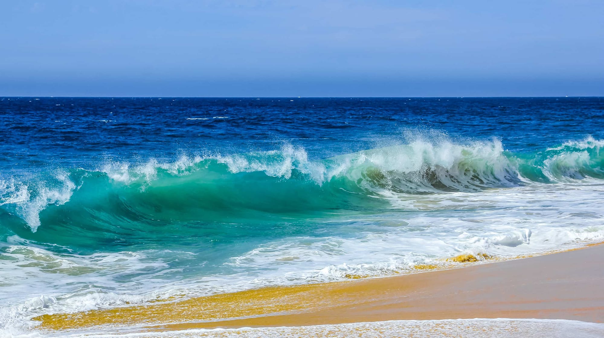 Ocean waves crashing on beach.