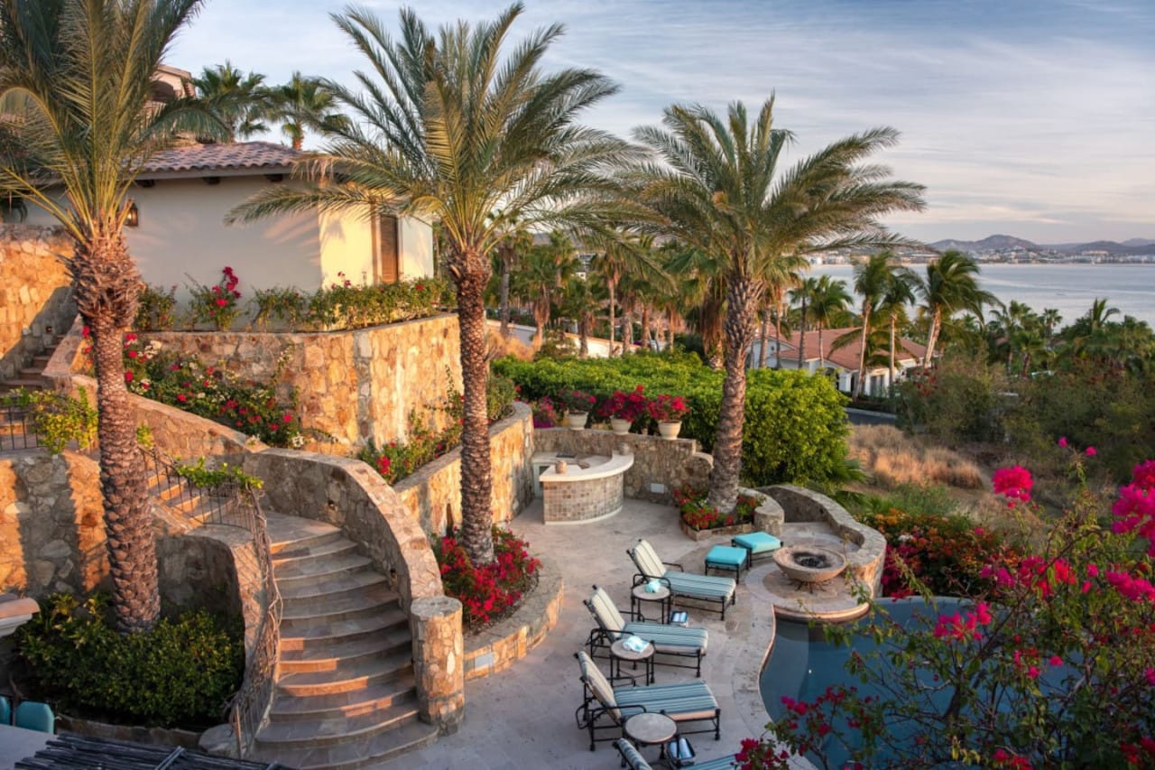 Luxury outdoor patio, stairs, ocean.