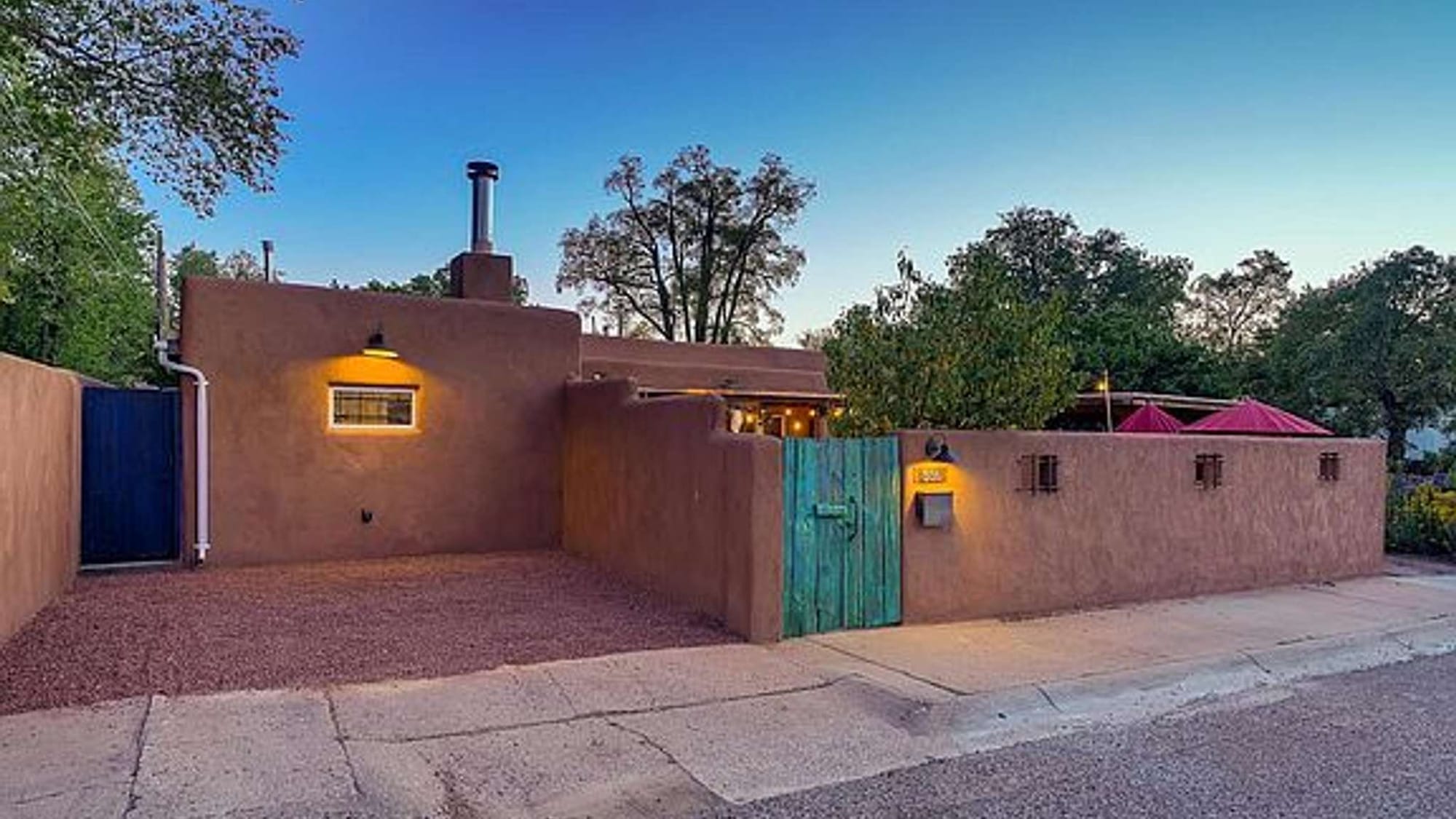 Adobe-style house with blue gate.