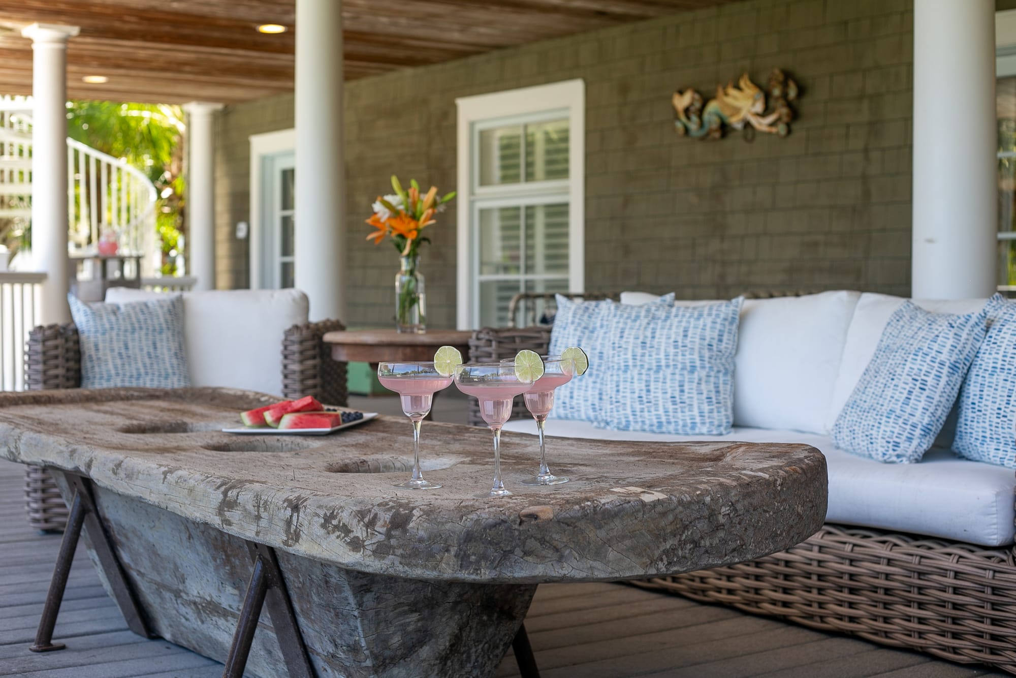 Patio with drinks and watermelon.