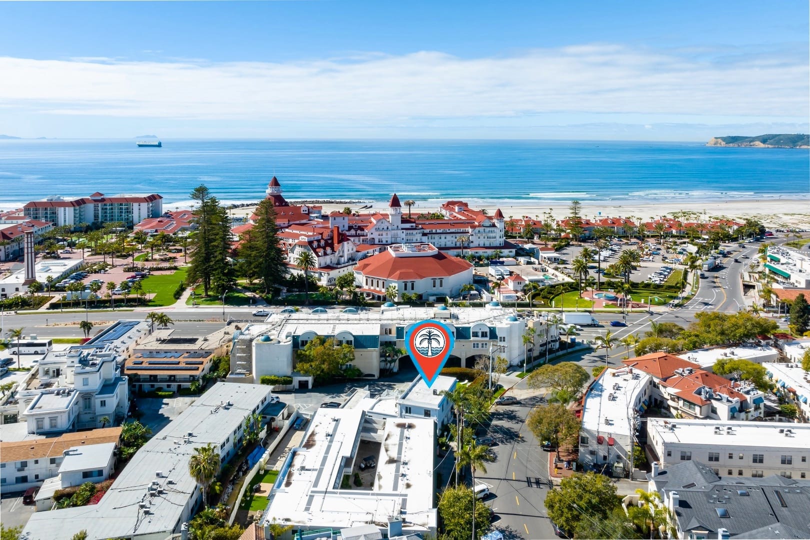 Beachfront town with large hotel.