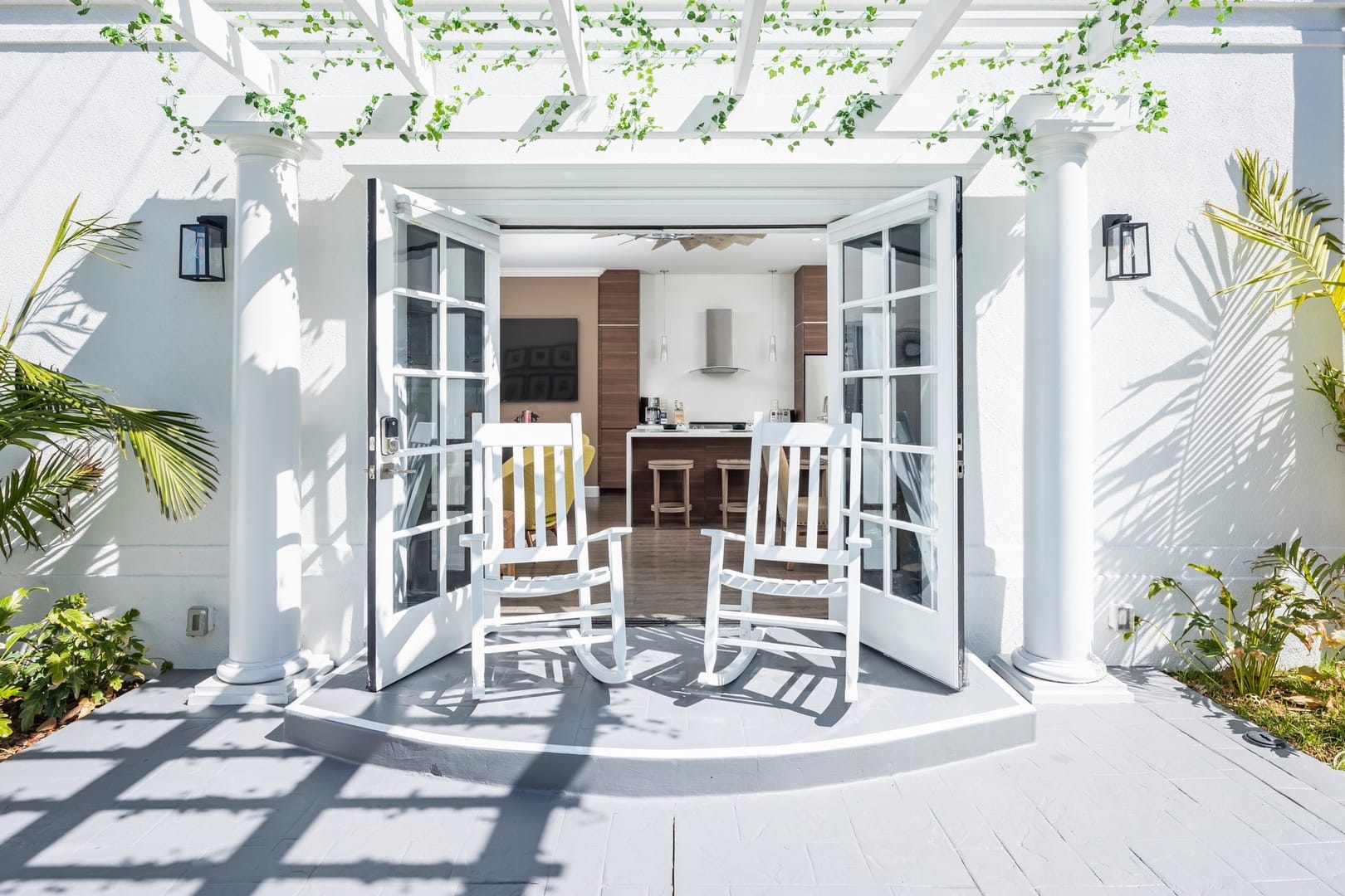 White rocking chairs on patio.