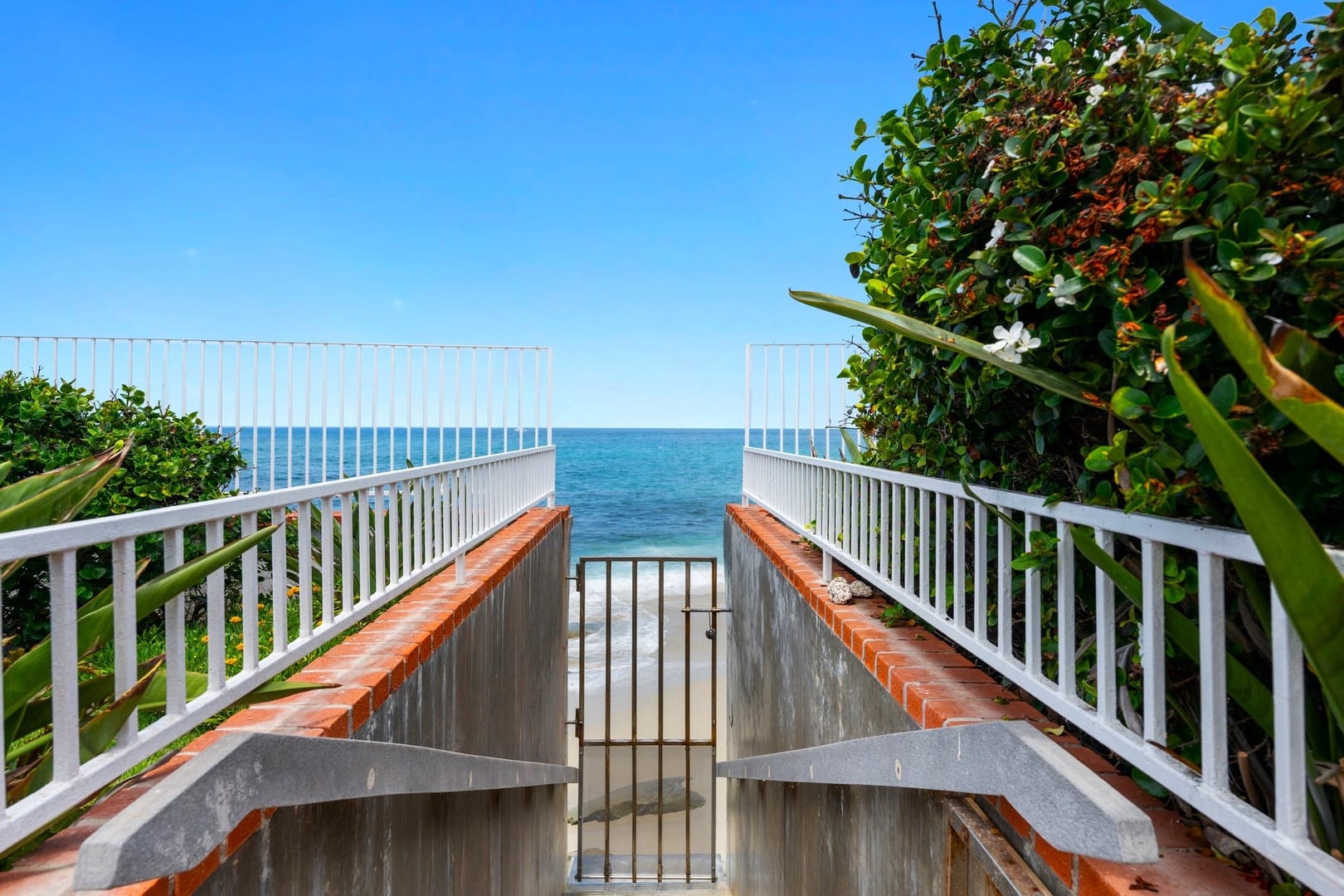 Gated beach access with ocean view.