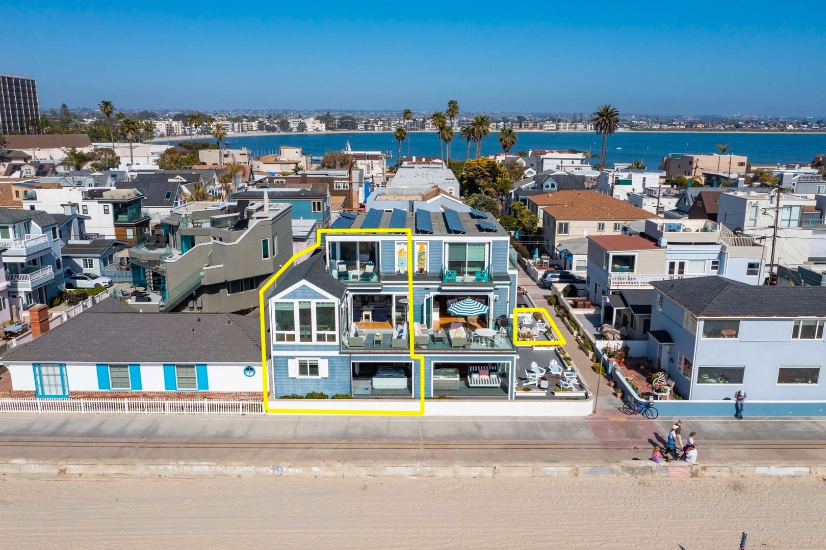 Beachfront blue house, multiple balconies.