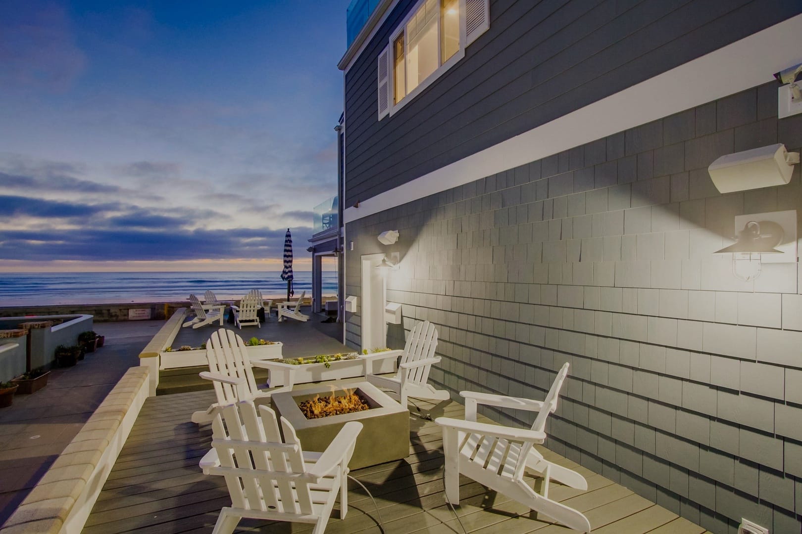 Patio chairs overlooking ocean sunset.