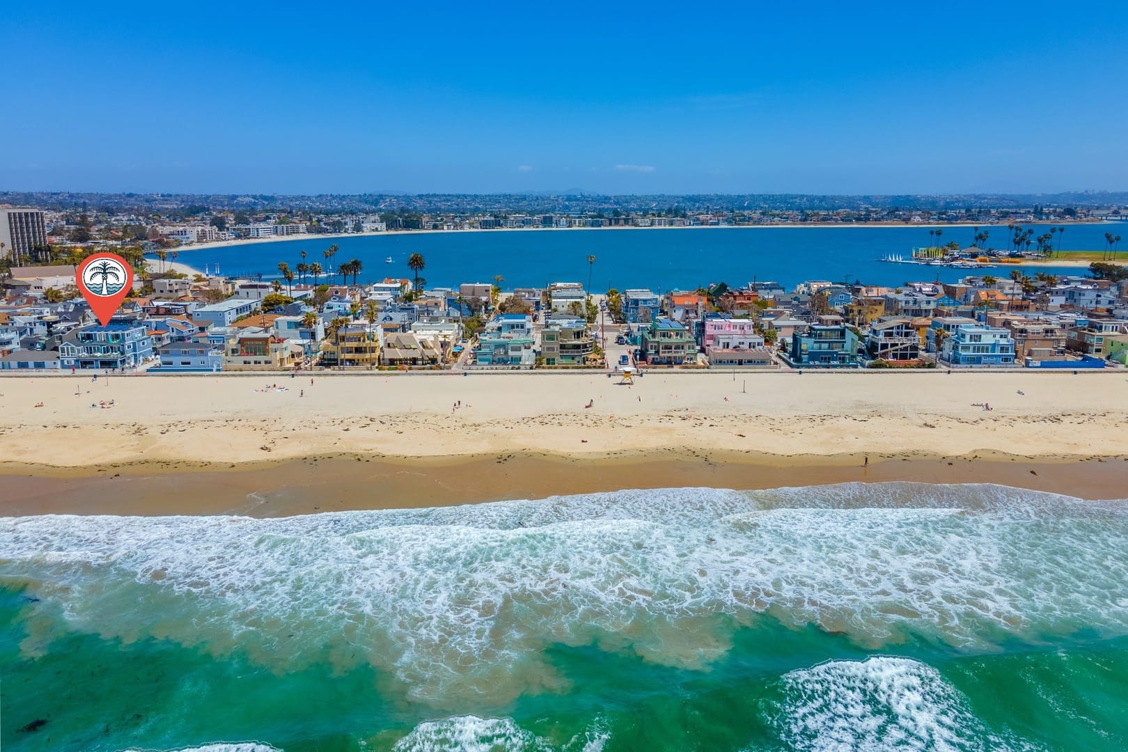 Beachfront houses by ocean and bay.