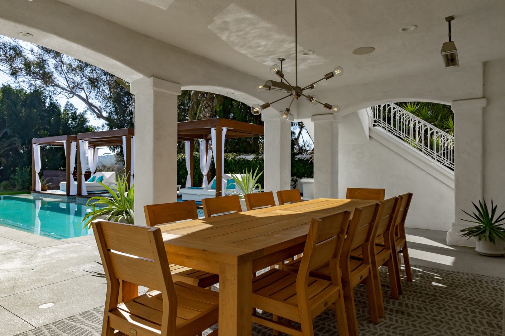 Patio dining area with poolside cabanas.