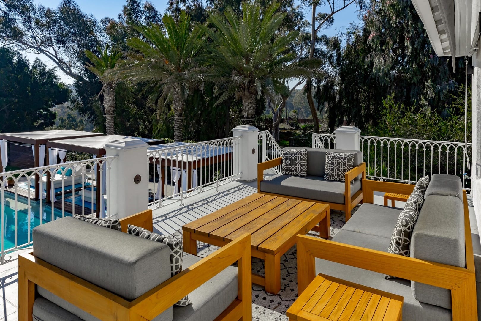 Outdoor patio with wooden furniture.