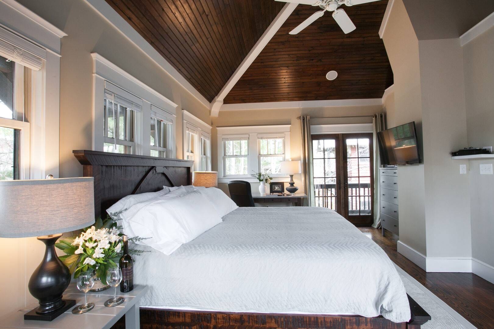 Bedroom with vaulted wood ceiling.