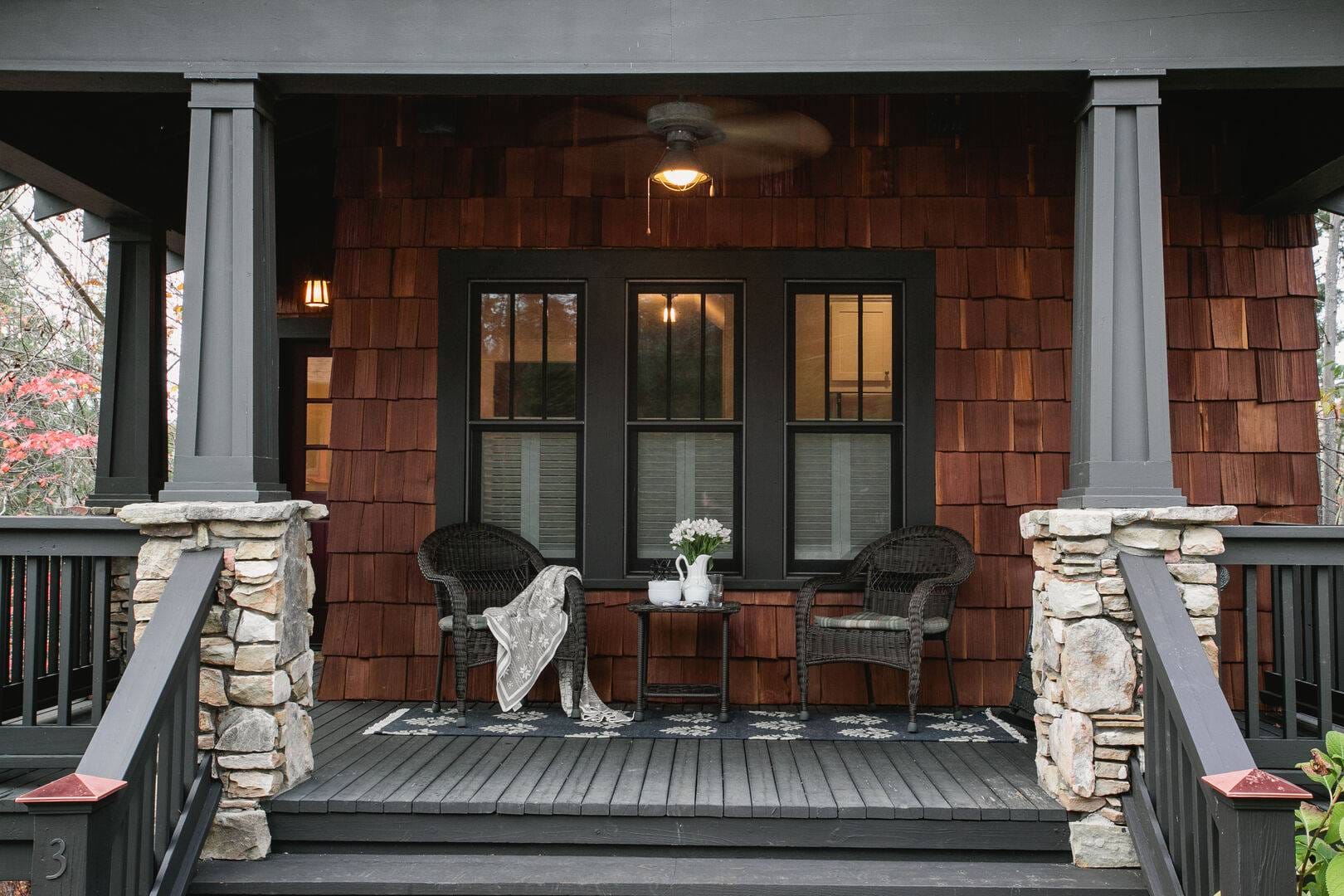 Cozy wooden porch with chairs.