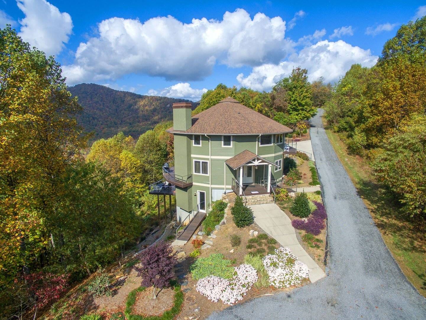 House on hill with mountainous background.