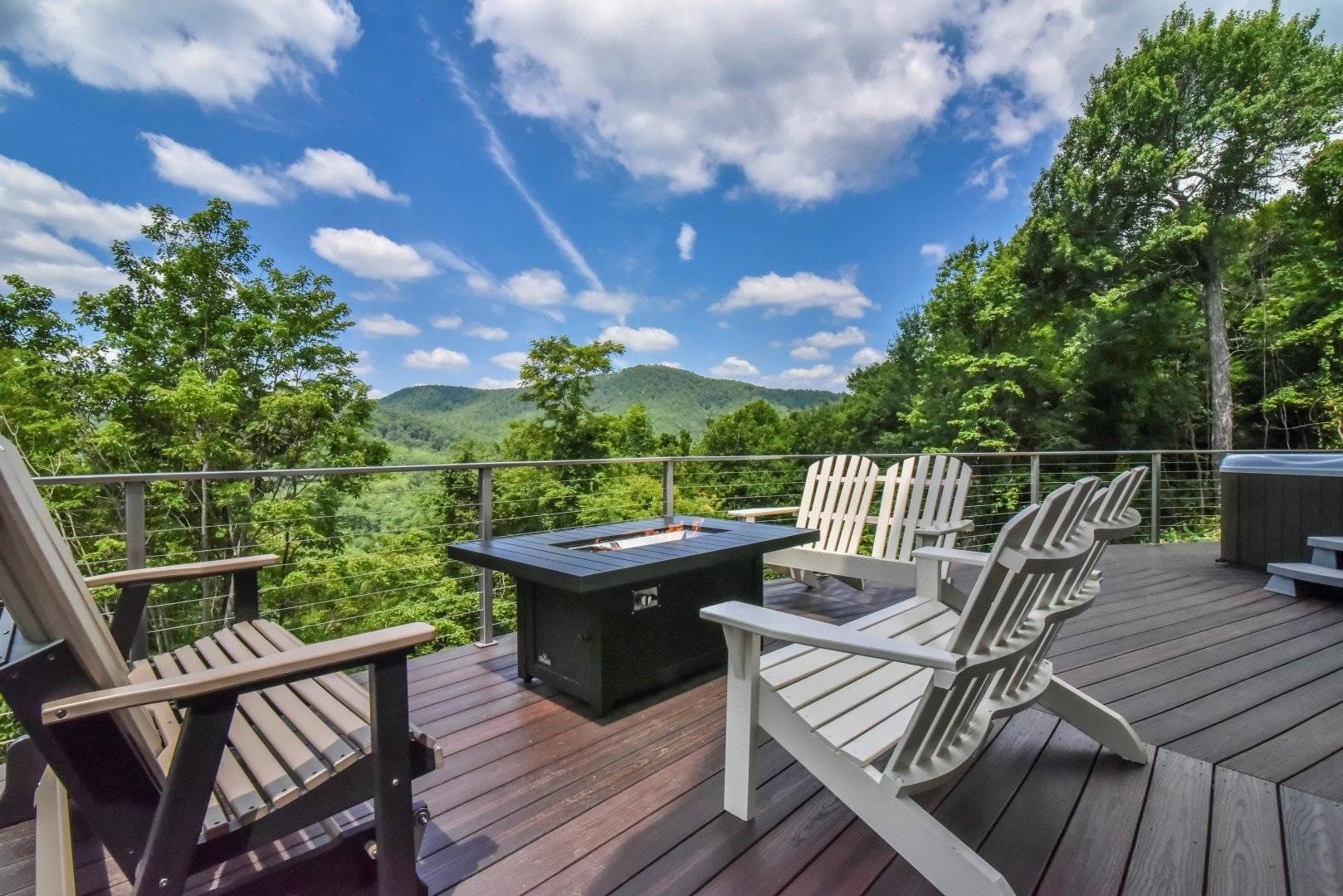 Mountain deck with chairs, firepit.